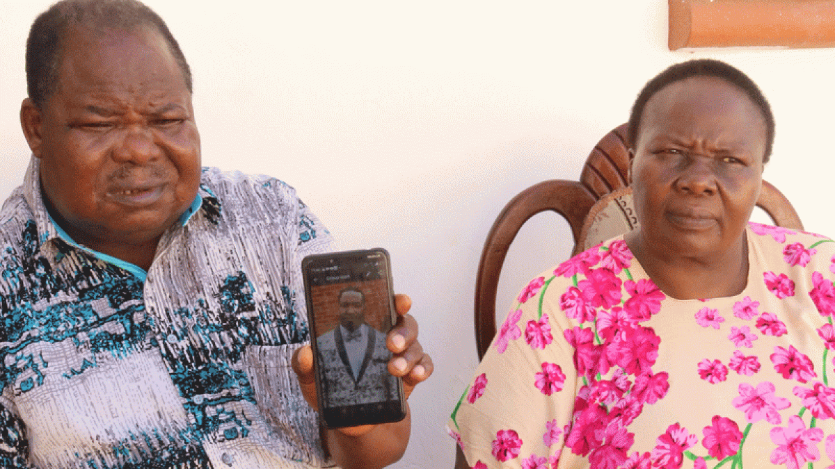 Bishop Elisha Juma and his wife Mary Juma display a phone photo of their son Peter 1200x675 1