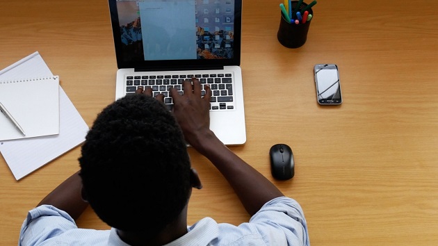 African-stock-video-of-a-black-man-typing-on-a-laptop-computer-